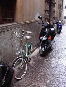 An old-fashioned
bicycle lines up next to a brand new moto.