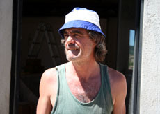 Giacconi taking a break from laying tile
