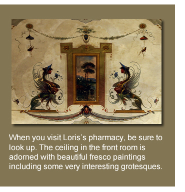 When you visit Loris’s pharmacy, be sure to look up. The ceiling in the front room is adorned with beautiful fresco paintings including some very interesting grotesques.  