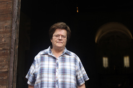 Gina stands in front of the church.
