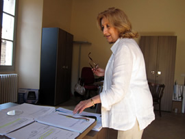 Maurizia organizing her work documents. 
