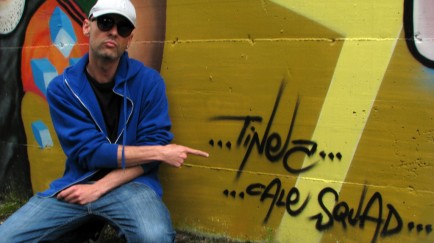 Simone "Tinez" Martinelli, grafitti artist, poses in front of his work.