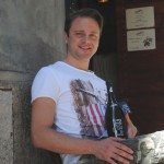 Owner Mauro Antonacci proudly displays his artisanal beer creation in front of Squaqua.