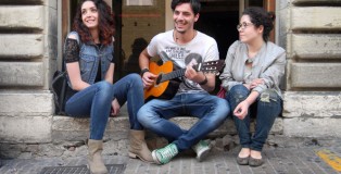 Students Giulia Ivanges and Martina Russano enjoy some free time between classes, listening along as a friend strums the guitar. The two will face a high Italian unemployment rate when they graduate.
