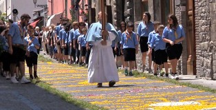 The scouts lead the local people and officials in the procession as they make their way around the town.