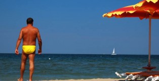 Yellow Speedo on a Blue Flag Beach