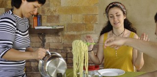 A large plate of pesto pasta is the centerpiece and is served to all. Pausa: A Fading Italian Tradition