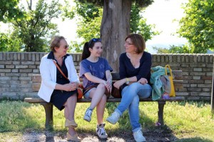 Grandmother, mother and daughter talk amongst themselves in the Fortezza.