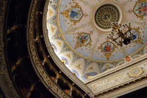 The beautifully detailed ceilings of the Cagli theater, enclosed by a section of the 500 seats that encircle the stage. 