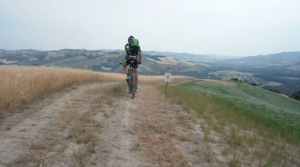 Piergiorgio Guelpa finishes a climb and prepares for the descent into a valley near Castello di Cavallino.