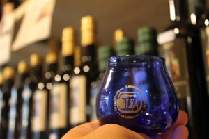 The olive oil tasting glass is blue to hide the color of the oil and prevent biases in a judge. Color is no indication of the quality of oil.