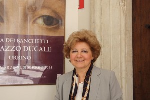 Maria Claudia Caldari poses in front of La Muta advertisement outside the Palazzo Ducale. 