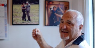 The walls of Tito Micheli's home office are covered in pictures of his family, including this one of him with his daughter, Silvia, on a hunting trip.